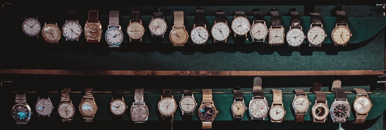 Rangées de vieilles montres-bracelets posées dans un plateau, en attente d'une seconde vie
